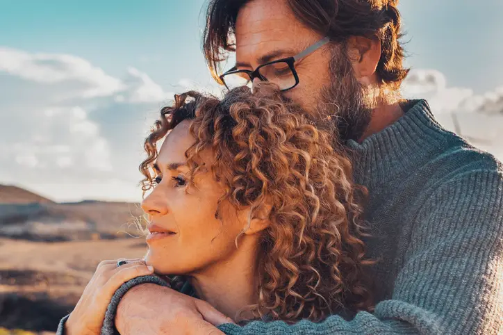 Young and healthy adult couple in love in outdoor leisure activity admiring travel destination.